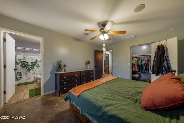 bedroom featuring connected bathroom, a closet, a spacious closet, and ceiling fan