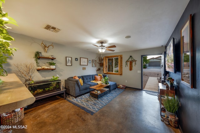 living room with ceiling fan and concrete floors