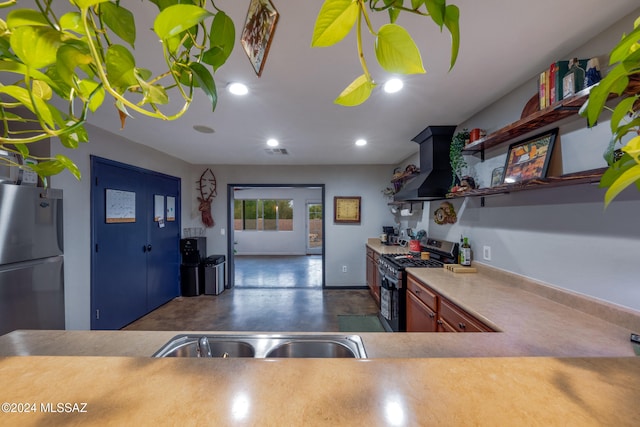 kitchen with sink, extractor fan, and appliances with stainless steel finishes