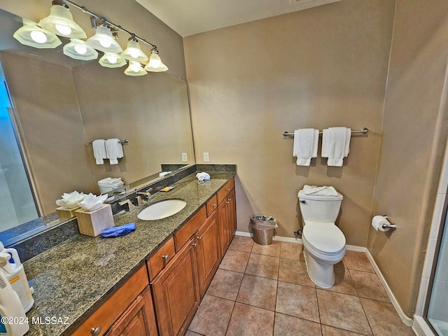 full bath featuring vanity, tile patterned flooring, toilet, and baseboards