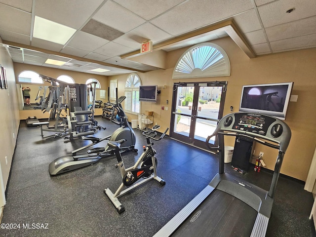 exercise room with french doors and a drop ceiling