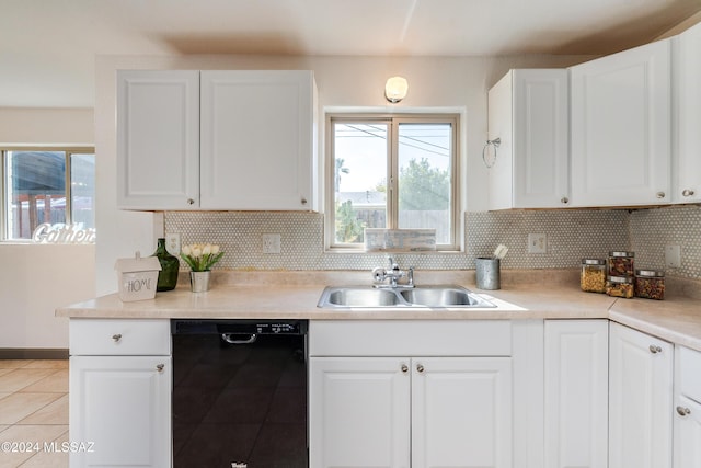 kitchen featuring sink, white cabinets, and black dishwasher