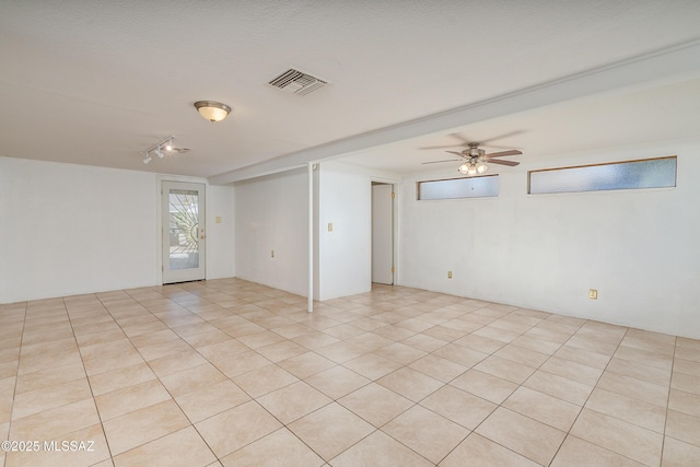 spare room with ceiling fan and light tile patterned flooring