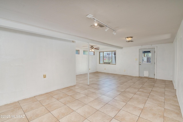 spare room with track lighting, light tile patterned flooring, and ceiling fan