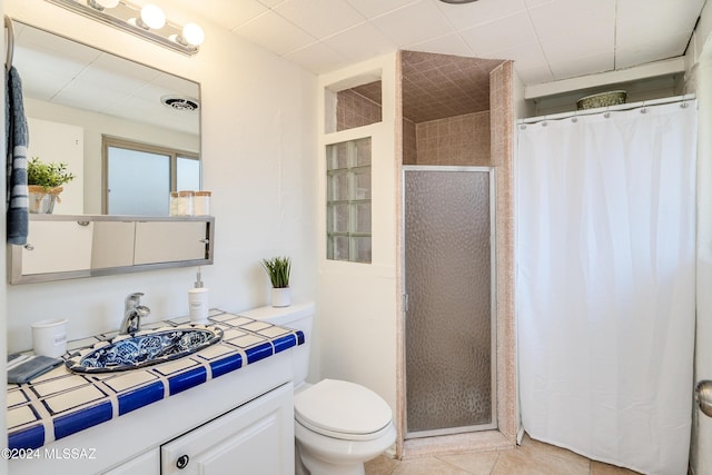 bathroom with a shower with shower curtain, tile patterned flooring, vanity, and toilet