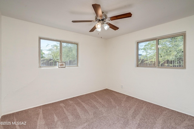 carpeted empty room featuring ceiling fan