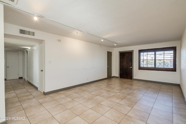 unfurnished room featuring light tile patterned floors