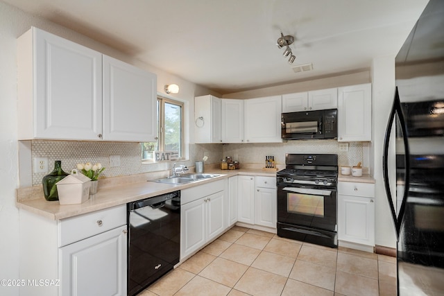 kitchen with black appliances, backsplash, white cabinets, light tile patterned flooring, and sink