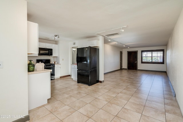 kitchen featuring black appliances, white cabinetry, light tile patterned flooring, and tasteful backsplash