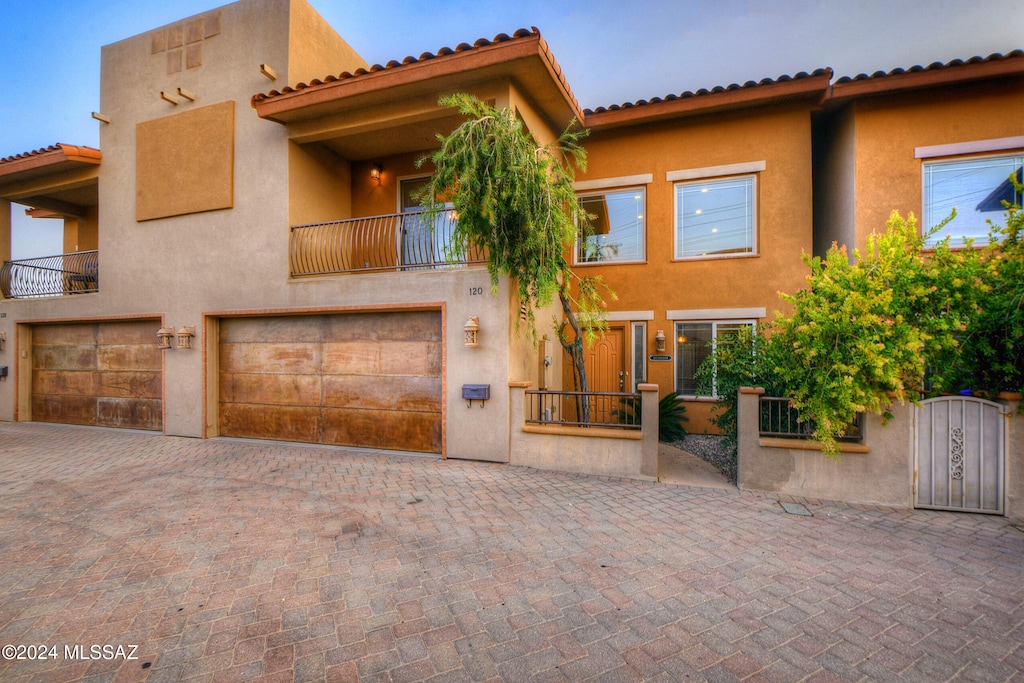 view of front of home featuring a garage and a balcony