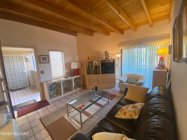 living room featuring wood ceiling, beamed ceiling, plenty of natural light, and light tile patterned floors