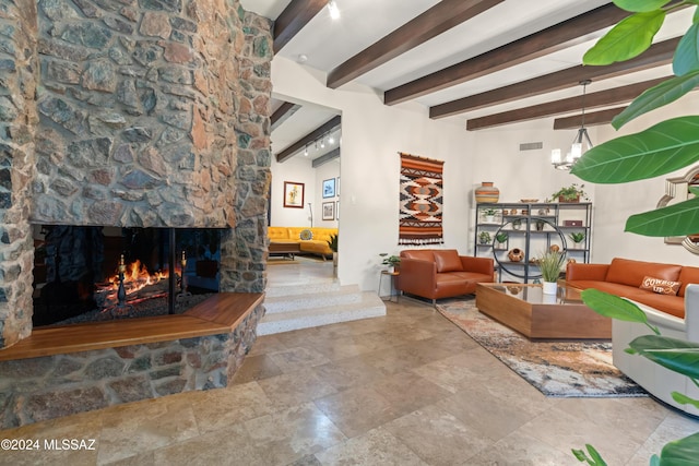 4750 N Calle Desecada, Tucson, AZ 85718 - living room with beamed ceiling, a stone fireplace, a chandelier, and stone finish flooring