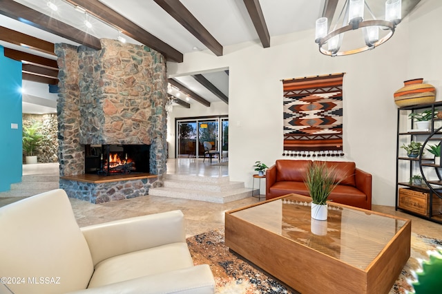 living room featuring beamed ceiling, a fireplace, and an inviting chandelier