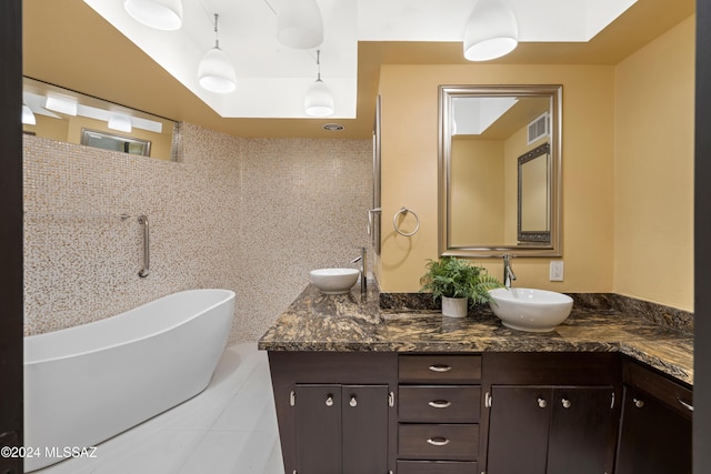 4750 N Calle Desecada, Tucson, AZ 85718 - bathroom featuring double vanity, a freestanding tub, and tile patterned flooring