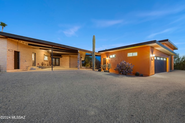 view of front facade featuring a garage and a carport