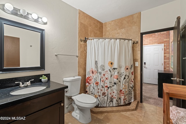 bathroom with a shower with curtain, vanity, tile walls, tile patterned flooring, and toilet