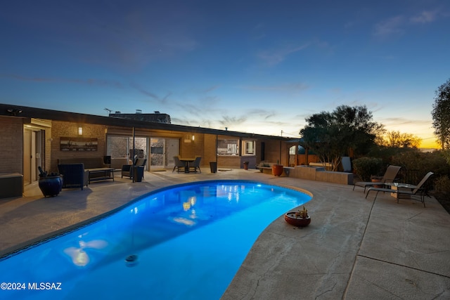 4750 N Calle Desecada, Tucson, AZ 85718 - pool at dusk featuring a patio and outdoor lounge area