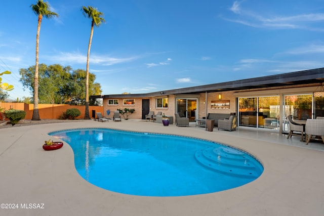 view of pool featuring outdoor lounge area and a patio area