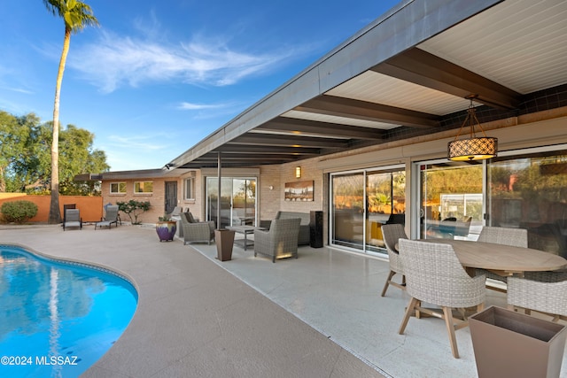 view of swimming pool with outdoor lounge area and a patio