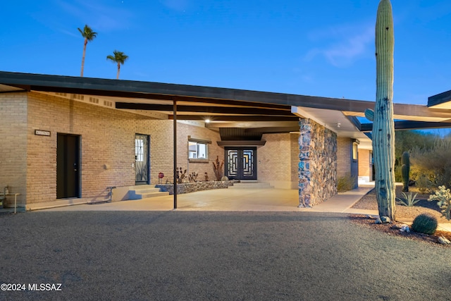 4750 N Calle Desecada, Tucson, AZ 85718 - rear view of property with brick siding, entry steps, and french doors