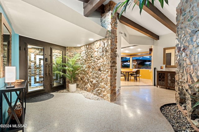 foyer entrance with beamed ceiling and french doors