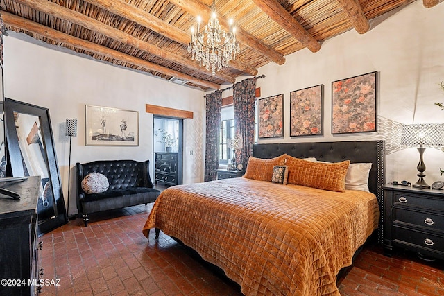 bedroom featuring beamed ceiling, a chandelier, wood ceiling, and brick floor