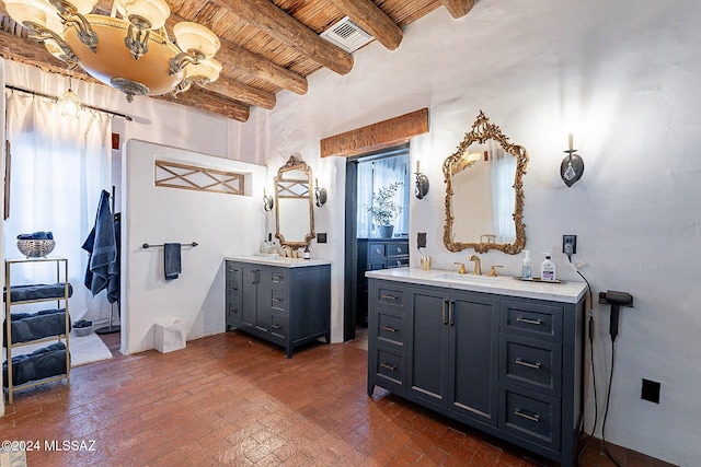 bathroom featuring a sink, wooden ceiling, brick floor, and two vanities