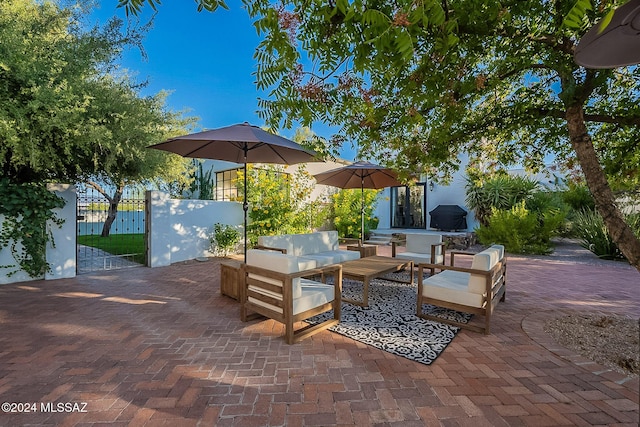 view of patio with an outdoor living space and fence