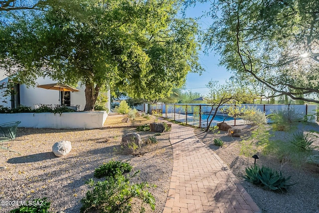 view of community with fence and a swimming pool