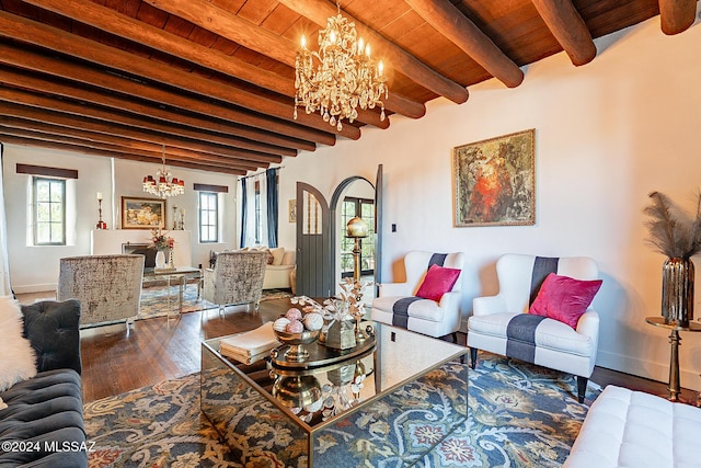 living area featuring wood ceiling, arched walkways, wood finished floors, and a notable chandelier