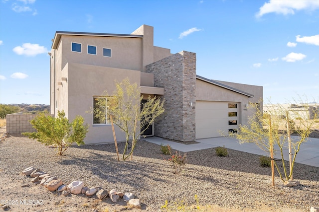 contemporary house with stucco siding