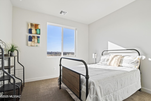 bedroom with baseboards, visible vents, and dark colored carpet