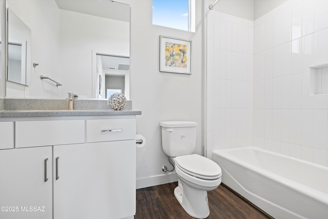 full bathroom featuring shower / bathtub combination, toilet, wood finished floors, vanity, and baseboards