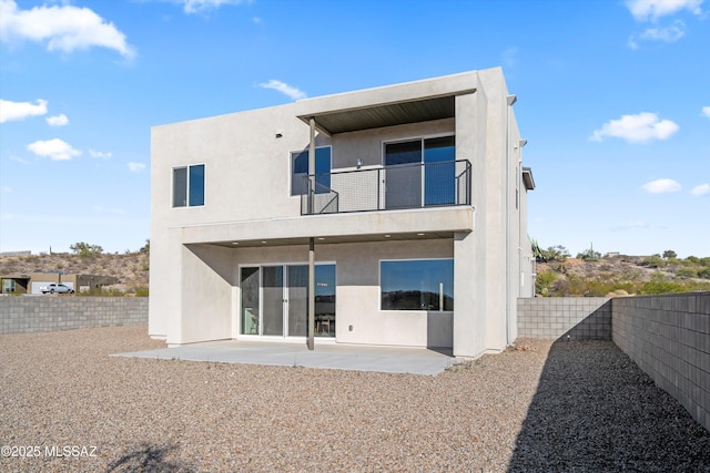 back of property with a patio, a fenced backyard, a balcony, and stucco siding