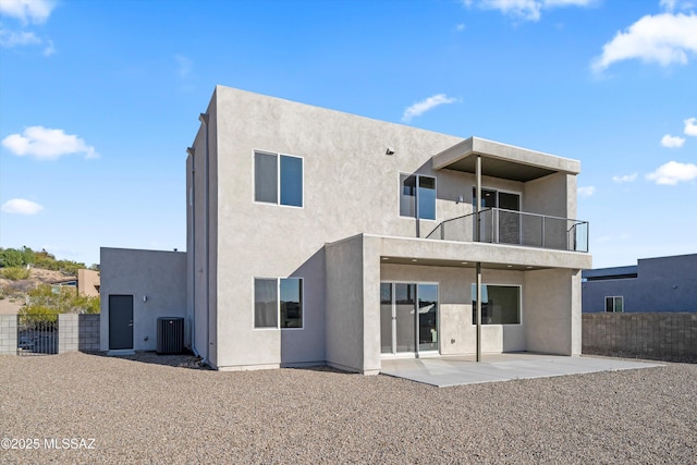 back of house featuring a patio area, fence, a balcony, and stucco siding