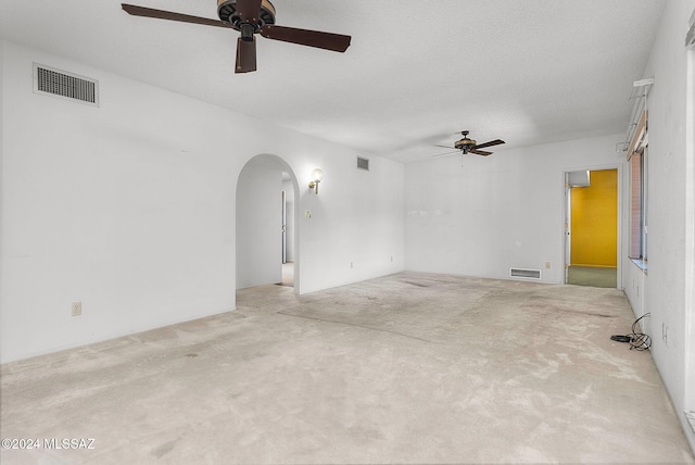 unfurnished room with light carpet, a textured ceiling, and ceiling fan