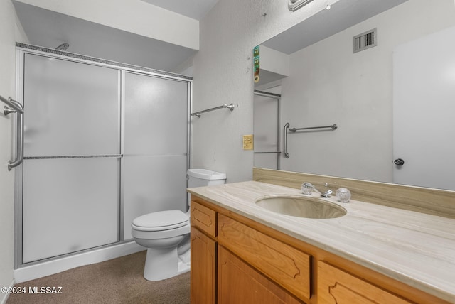 bathroom with vanity, toilet, and walk in shower