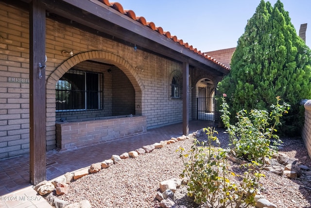 view of side of home featuring covered porch