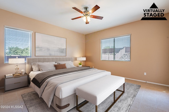 tiled bedroom featuring lofted ceiling and ceiling fan