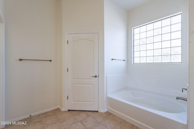 bathroom featuring a bath and tile patterned flooring