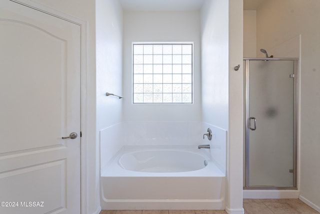 bathroom featuring tile patterned floors and independent shower and bath