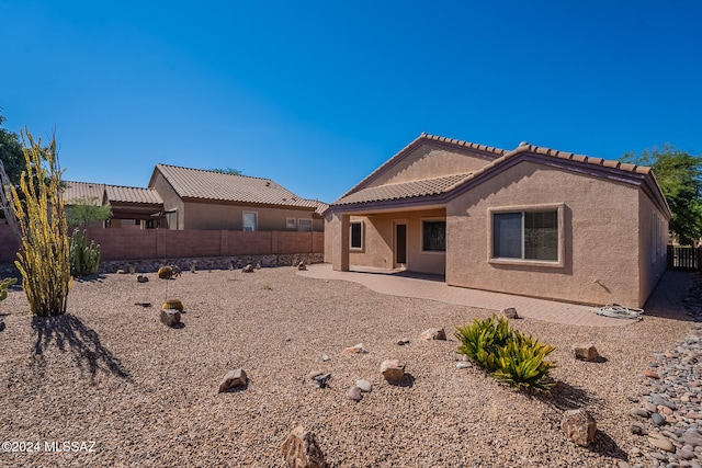 back of house with a patio area