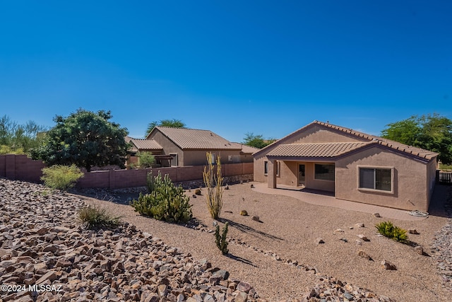 rear view of property featuring a patio