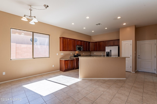 kitchen featuring appliances with stainless steel finishes, a kitchen island with sink, light tile patterned flooring, pendant lighting, and a notable chandelier