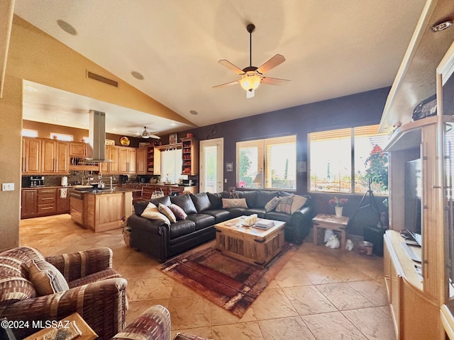 living room featuring ceiling fan and vaulted ceiling