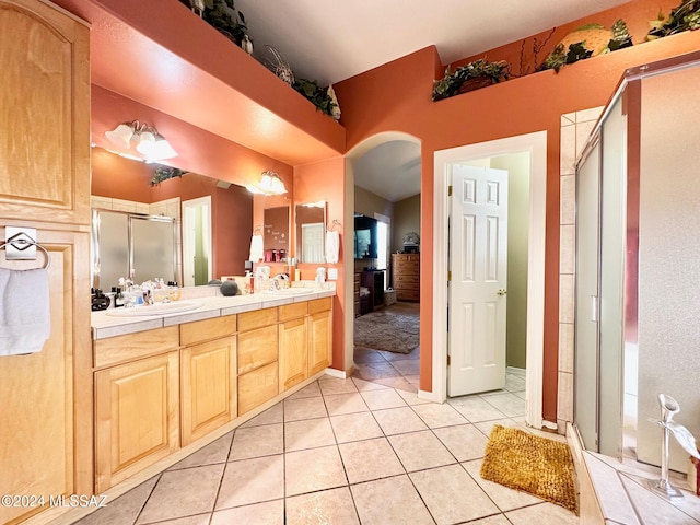 bathroom with tile patterned floors, vanity, and a shower with shower door