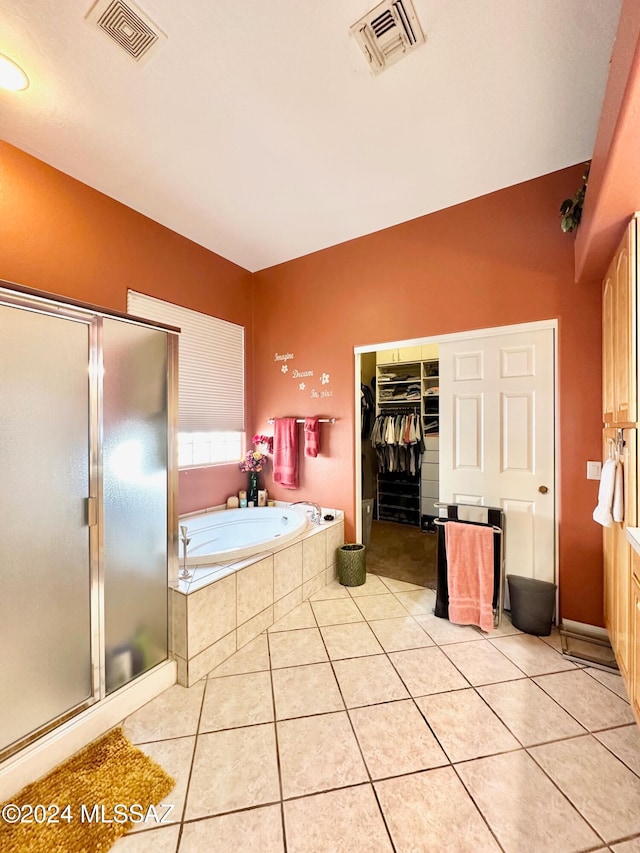 bathroom featuring tile patterned flooring and shower with separate bathtub