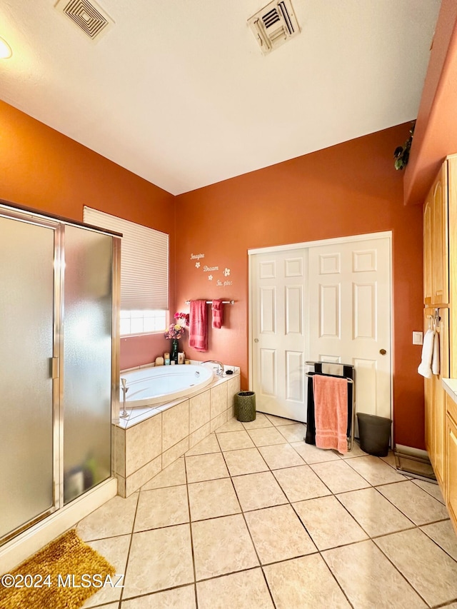 bathroom with tile patterned floors, vanity, and independent shower and bath