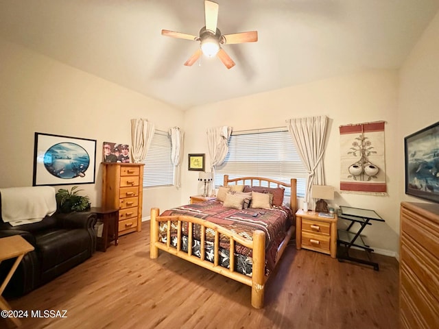 bedroom featuring hardwood / wood-style flooring, ceiling fan, and vaulted ceiling