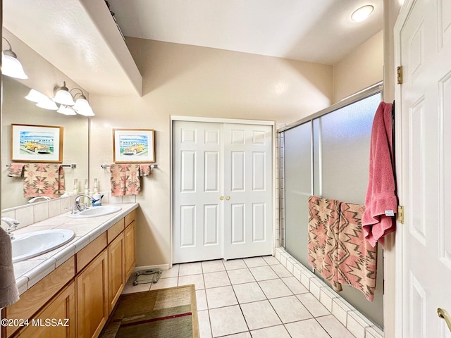 bathroom with tile patterned floors, vanity, and walk in shower